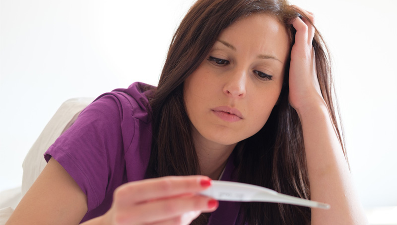 young woman checking home pregnancy test results
