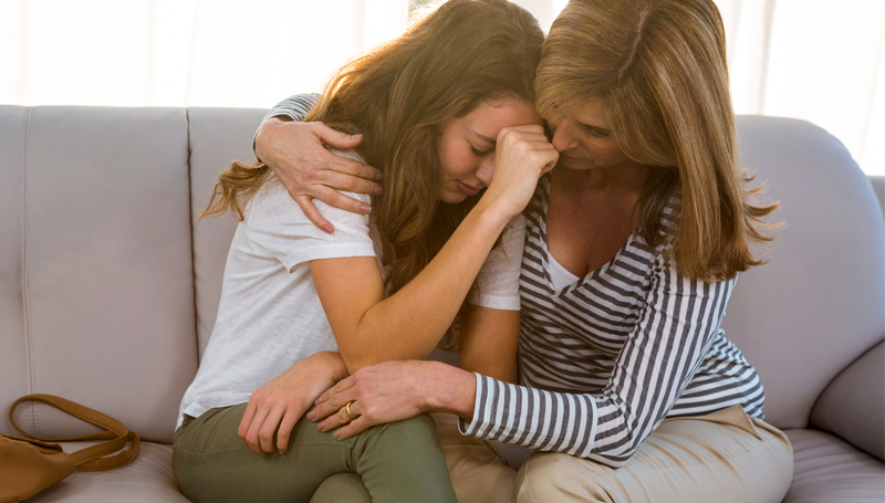 mom consoling teen daughter