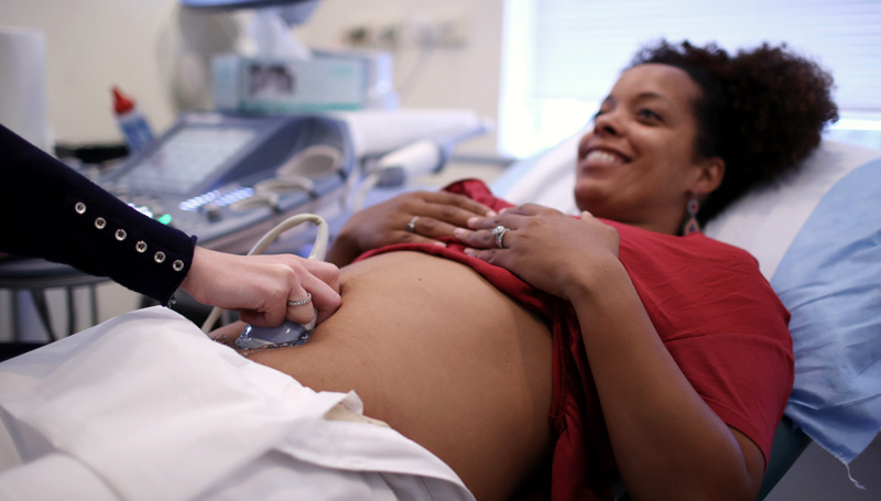 pregnant woman smiling during ultrasound
