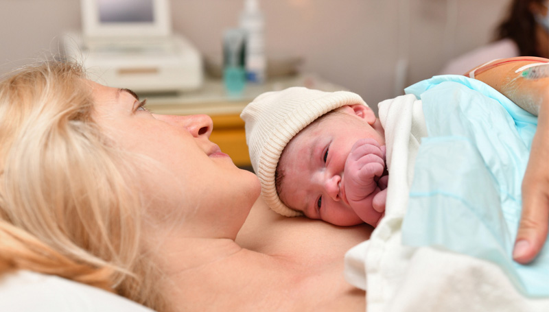 birth mother holding newborn in hospital