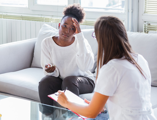 young woman talking with client advocate