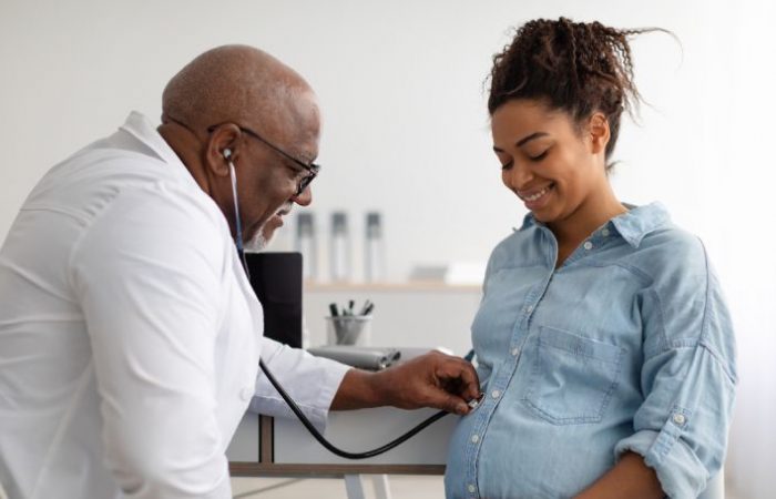 pregnant woman being examined by doctor
