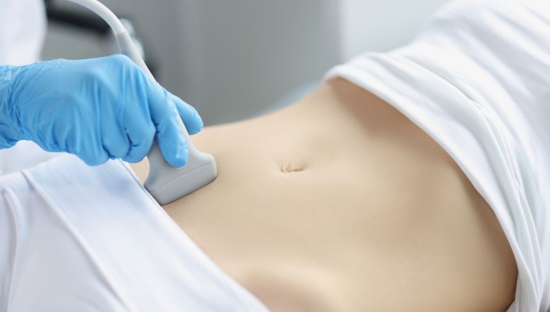 closeup of woman undergoing a pregnancy confirmation ultrasound exam