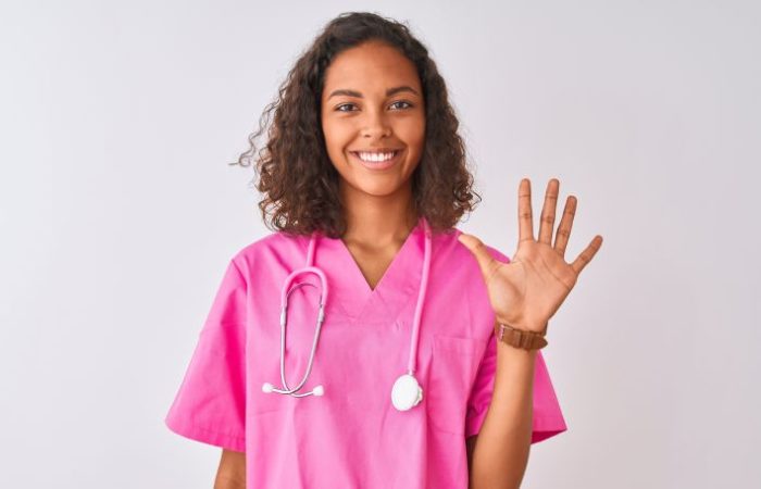 nurse holding up five fingers
